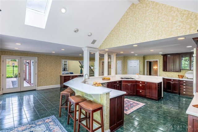 533 Lockerbie Ln, Kettering, OH 45429 - kitchen with wallpapered walls, a spacious island, plenty of natural light, light countertops, and high vaulted ceiling