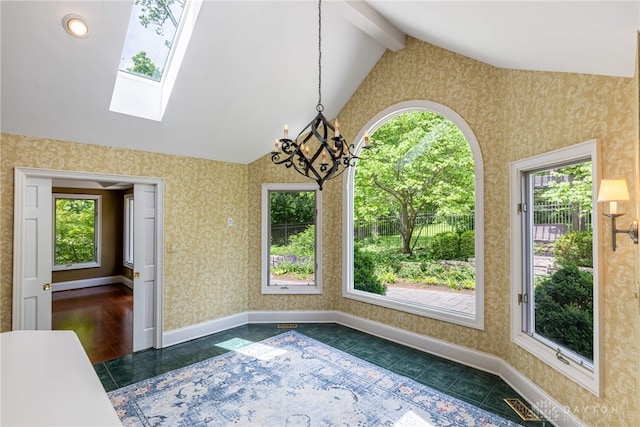 533 Lockerbie Ln, Kettering, OH 45429 - unfurnished dining area with dark tile patterned flooring, healthy amount of natural light, a skylight, and wallpapered walls