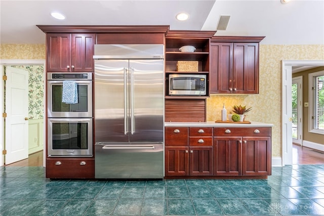 533 Lockerbie Ln, Kettering, OH 45429 - kitchen with appliances with stainless steel finishes, dark brown cabinets, wallpapered walls, open shelves, and dark tile patterned floors