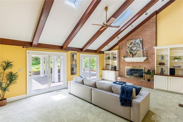 533 Lockerbie Ln, Kettering, OH 45429 - carpeted living area featuring a skylight, beam ceiling, a brick fireplace, healthy amount of natural light, and high vaulted ceiling
