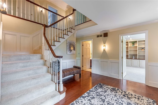 533 Lockerbie Ln, Kettering, OH 45429 - stairs with hardwood / wood-style flooring, a decorative wall, crown molding, and wainscoting