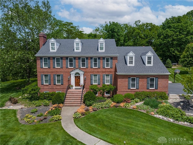 533 Lockerbie Ln, Kettering, OH 45429 - view of front of house featuring brick siding, a chimney, and a front yard