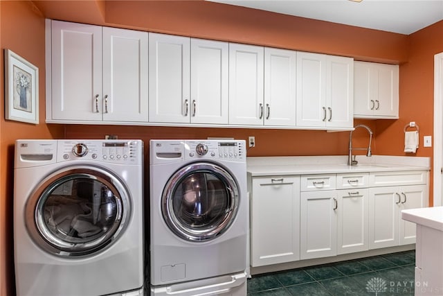 533 Lockerbie Ln, Kettering, OH 45429 - laundry room featuring cabinet space, separate washer and dryer, and dark tile patterned floors