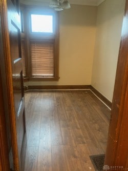 spare room featuring hardwood / wood-style floors and baseboards