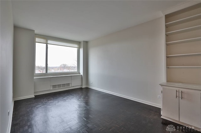 spare room featuring baseboards and visible vents