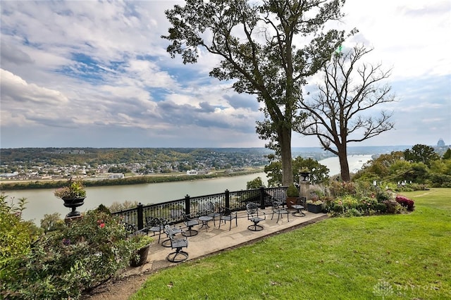 view of yard with a water view and a patio area