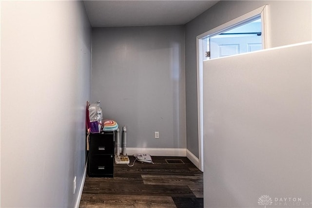 interior space with baseboards and wood finished floors