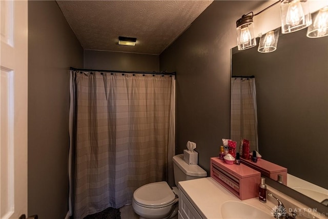 full bathroom featuring toilet, a textured ceiling, and vanity