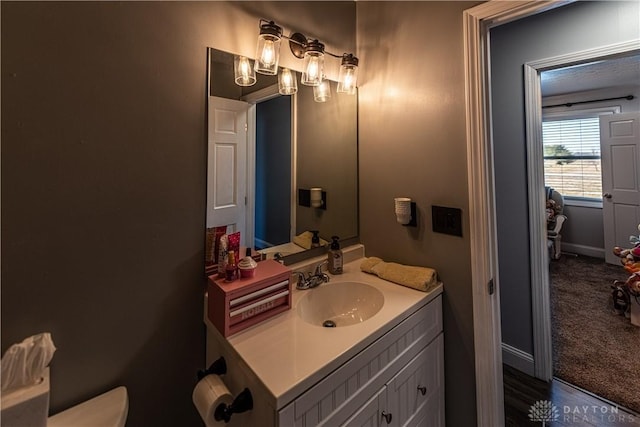 bathroom featuring toilet and vanity