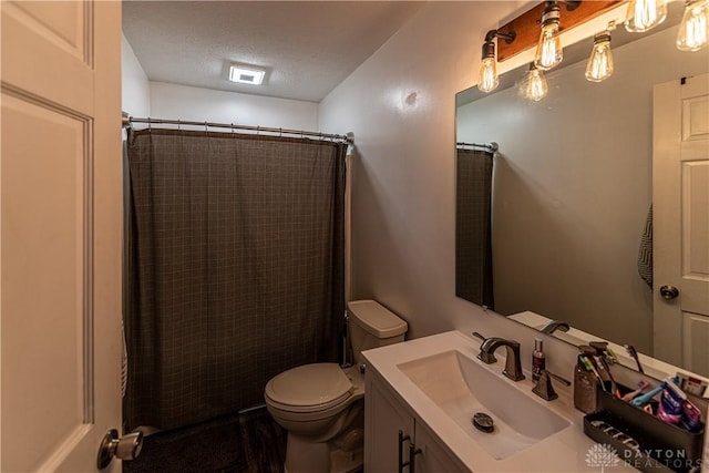full bath with toilet, curtained shower, a textured ceiling, and vanity