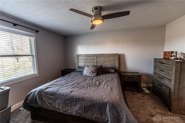 bedroom featuring a textured ceiling, baseboards, a ceiling fan, and carpet floors