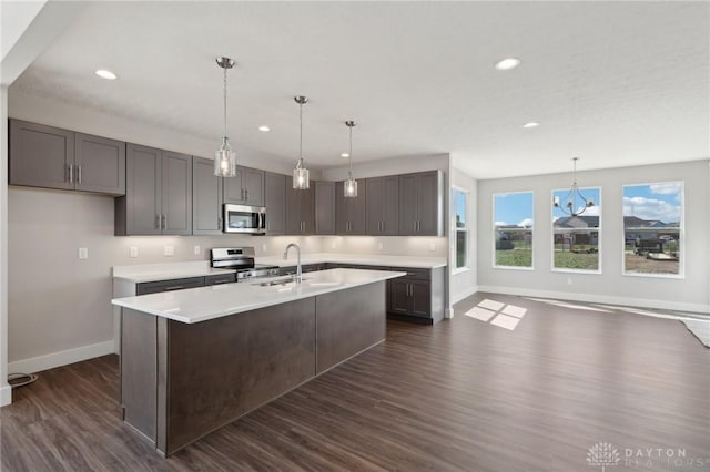 kitchen with light countertops, recessed lighting, stainless steel appliances, dark wood-style floors, and pendant lighting