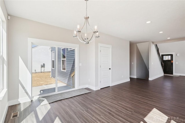 interior space featuring an inviting chandelier, dark wood-type flooring, baseboards, and visible vents
