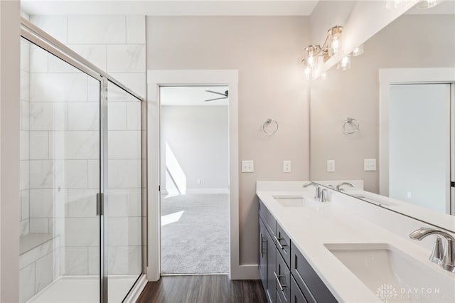 full bathroom with a stall shower and a sink