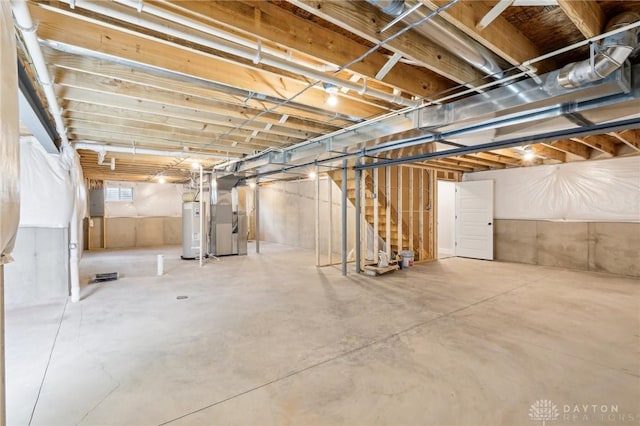below grade area with water heater, stairs, and heating unit