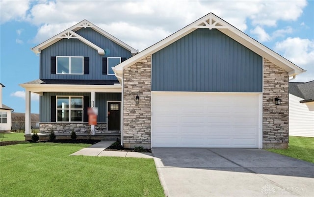 craftsman-style home featuring stone siding, a front yard, and an attached garage