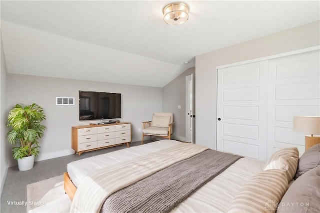 bedroom featuring baseboards, lofted ceiling, visible vents, and a closet
