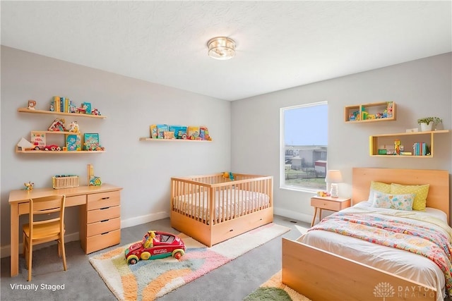 carpeted bedroom featuring baseboards