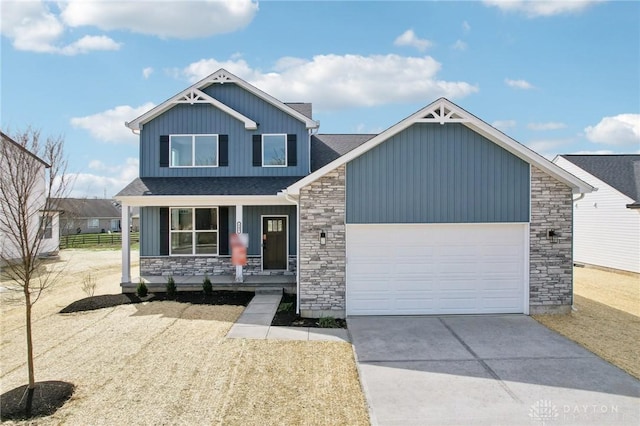 craftsman inspired home with stone siding, covered porch, a garage, and driveway