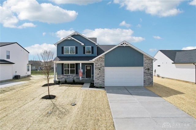 craftsman-style home with stone siding, a porch, an attached garage, and concrete driveway