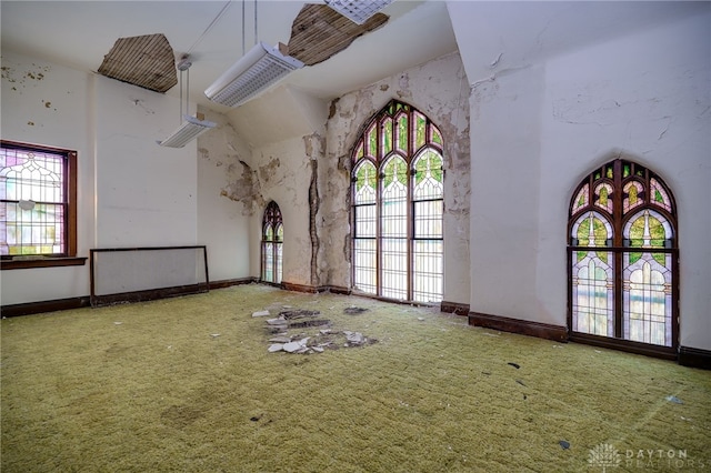 531 W Ash St, Piqua, OH 45356 - spare room with a high ceiling, carpet, and arched walkways