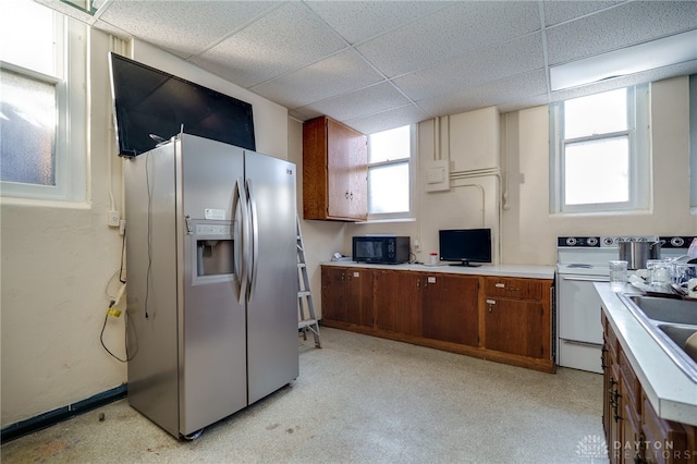 531 W Ash St, Piqua, OH 45356 - kitchen with stainless steel fridge with ice dispenser, black microwave, white range with electric cooktop, light countertops, and a drop ceiling