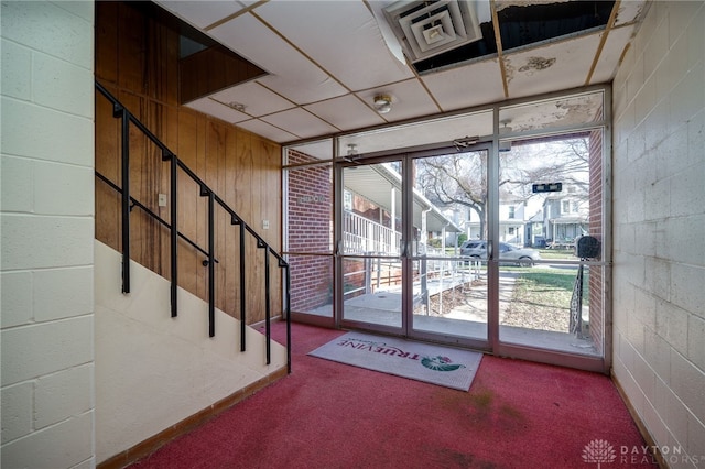 531 W Ash St, Piqua, OH 45356 - doorway to outside featuring carpet floors and concrete block wall