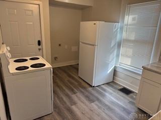 114 N Garland Ave, Dayton, OH 45403 - kitchen with dark wood-style flooring, white cabinets, light countertops, white appliances, and baseboards