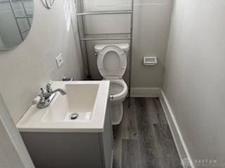 114 N Garland Ave, Dayton, OH 45403 - bathroom with baseboards, toilet, vanity, and wood finished floors