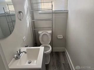 114 N Garland Ave, Dayton, OH 45403 - bathroom featuring toilet, vanity, baseboards, and wood finished floors