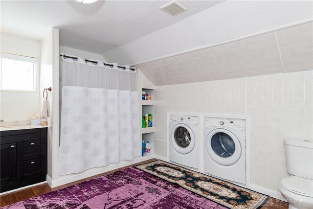 82 Notre Dame Ave, Dayton, OH 45404 - laundry room with washing machine and dryer, wood finished floors, and tile walls