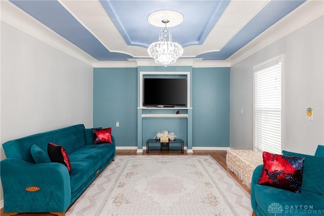 82 Notre Dame Ave, Dayton, OH 45404 - living room featuring a raised ceiling, a chandelier, wood finished floors, baseboards, and crown molding