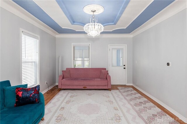 82 Notre Dame Ave, Dayton, OH 45404 - living area with a tray ceiling, a chandelier, wood finished floors, ornamental molding, and baseboards