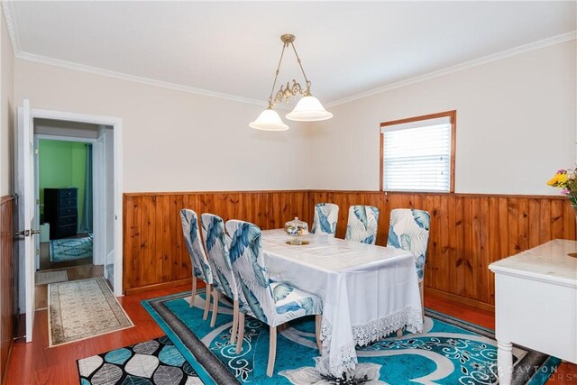 82 Notre Dame Ave, Dayton, OH 45404 - dining space featuring a wainscoted wall, wood finished floors, crown molding, and wood walls