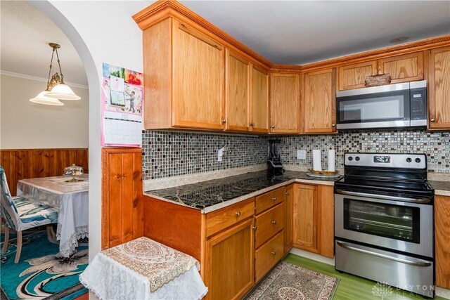 82 Notre Dame Ave, Dayton, OH 45404 - kitchen featuring stainless steel appliances, ornamental molding, backsplash, wainscoting, and arched walkways