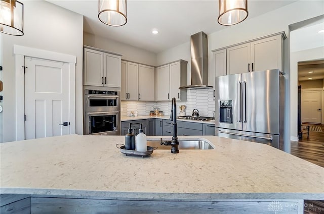 703 Doral Ct, Dayton, OH 45458 - kitchen featuring stainless steel appliances, wall chimney exhaust hood, gray cabinetry, light stone countertops, and recessed lighting