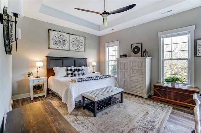 703 Doral Ct, Dayton, OH 45458 - bedroom featuring a tray ceiling, wood finished floors, and ceiling fan