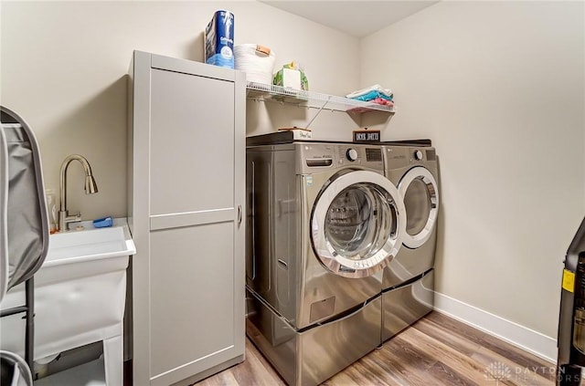 703 Doral Ct, Dayton, OH 45458 - laundry room with separate washer and dryer and light wood-type flooring