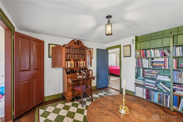 office space with baseboards and wood finished floors