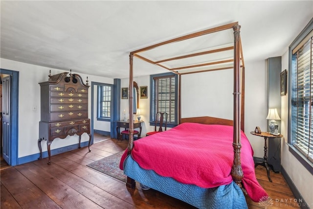 bedroom featuring wood-type flooring and baseboards