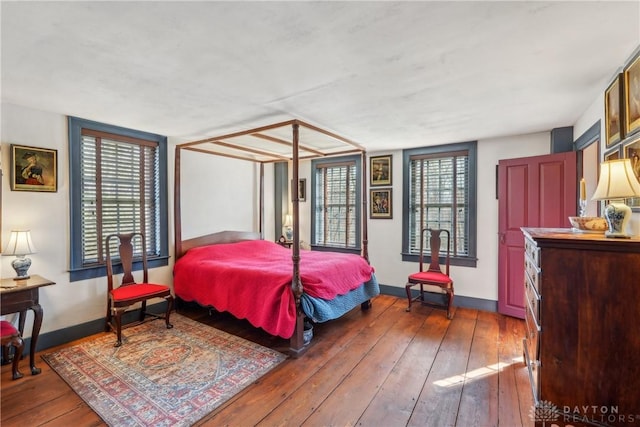 bedroom featuring hardwood / wood-style floors and baseboards