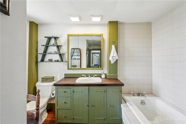 full bath with toilet, vanity, and a bath