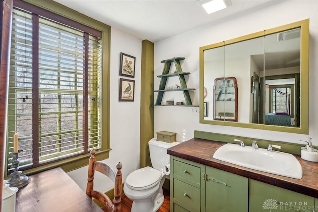 bathroom with toilet and vanity