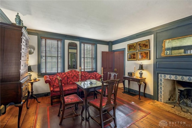 dining room with hardwood / wood-style flooring and baseboards