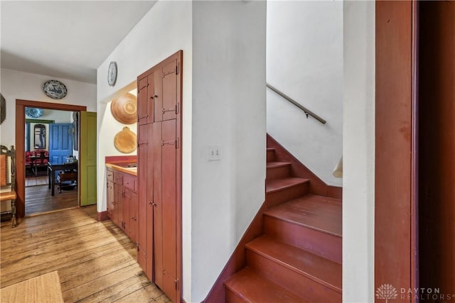 stairs with hardwood / wood-style flooring