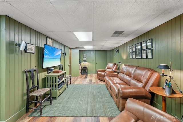 living room featuring visible vents, a paneled ceiling, and wood finished floors