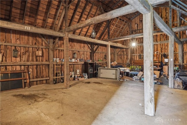 miscellaneous room featuring a garage and high vaulted ceiling