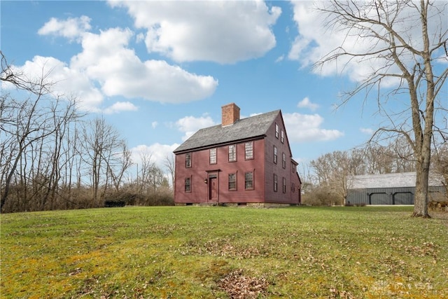 view of home's exterior featuring a lawn and a chimney