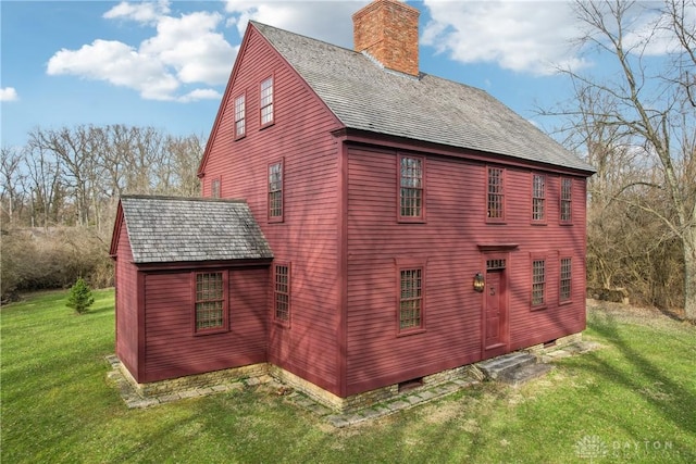 view of property exterior featuring a lawn and a chimney