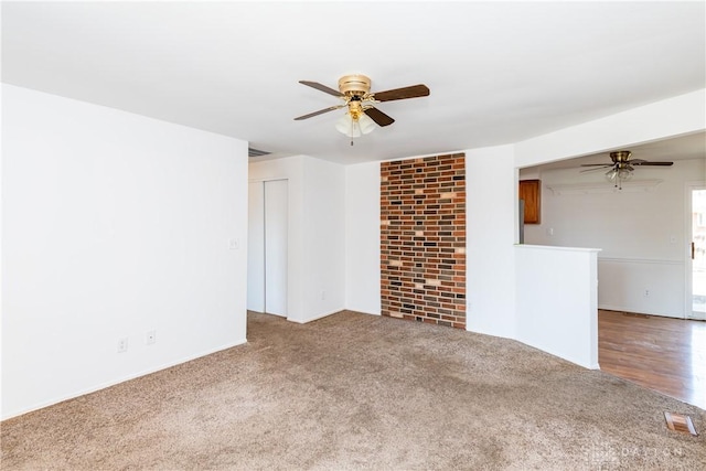 carpeted empty room with a ceiling fan